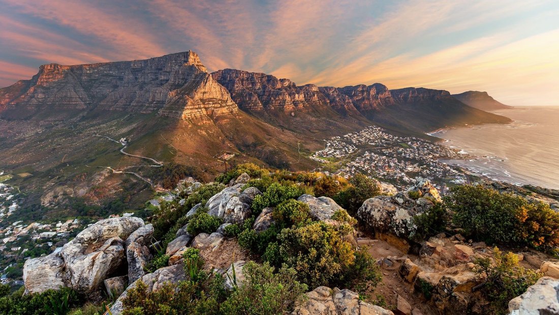 Sunset view over Table Mountain and the coastline of Cape Town, South Africa.