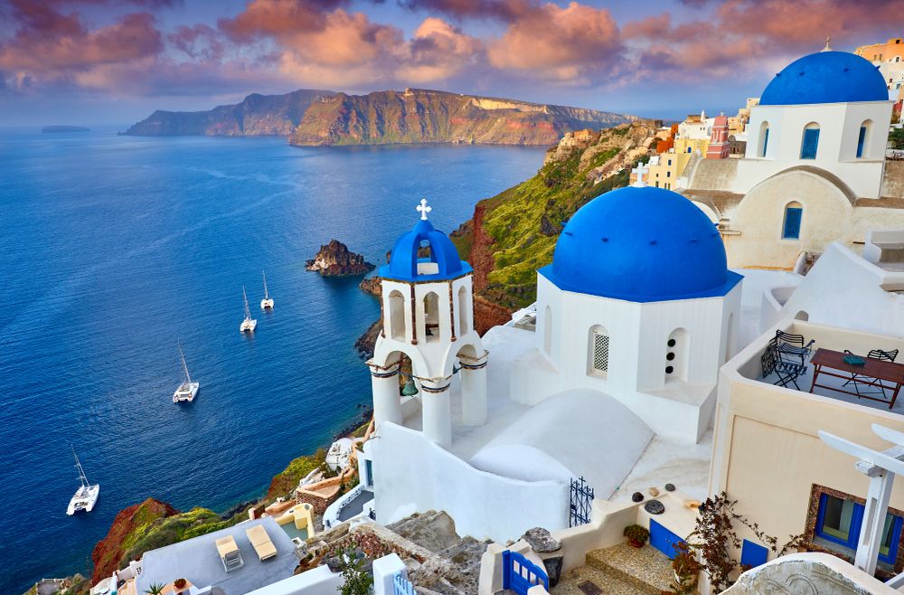 Blue-domed churches overlooking the caldera in Santorini, Greece.