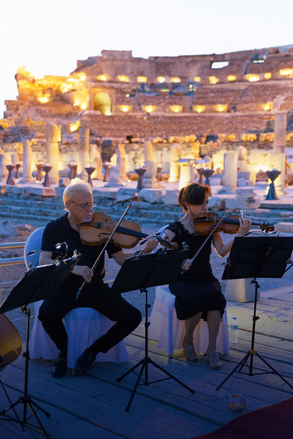 classical musicians playing outdoors at dusk