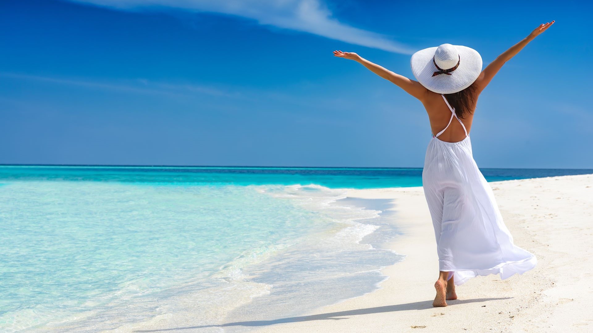 woman on beach with stretched arms
