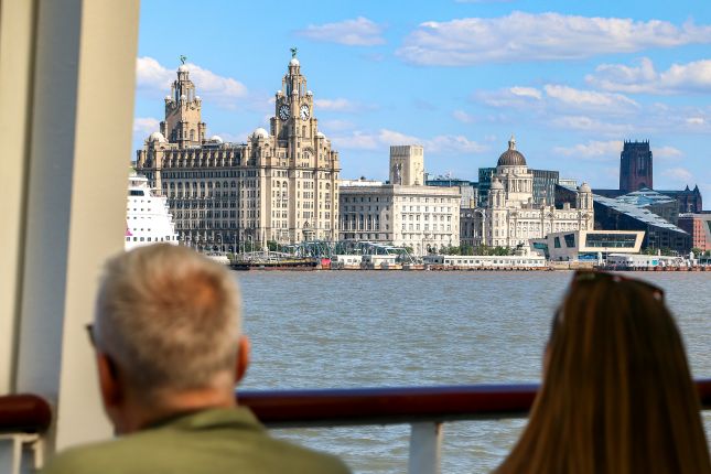 Visitors viewing Liverpool’s skyline from the Mersey