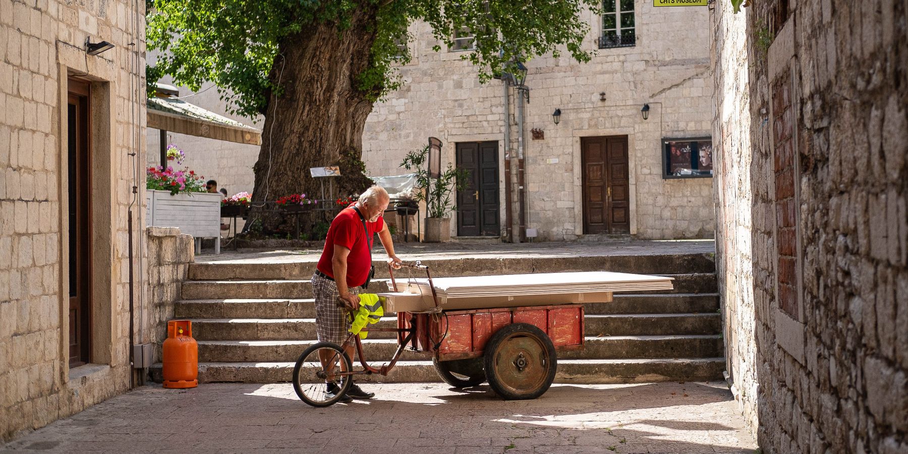 Local vendor in a stone lane in Kotor Old Town