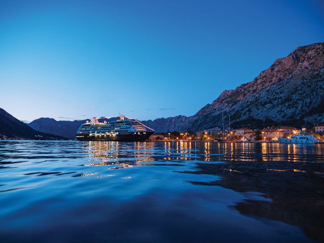 Azamara cruise ship illuminated in Kotor at dusk