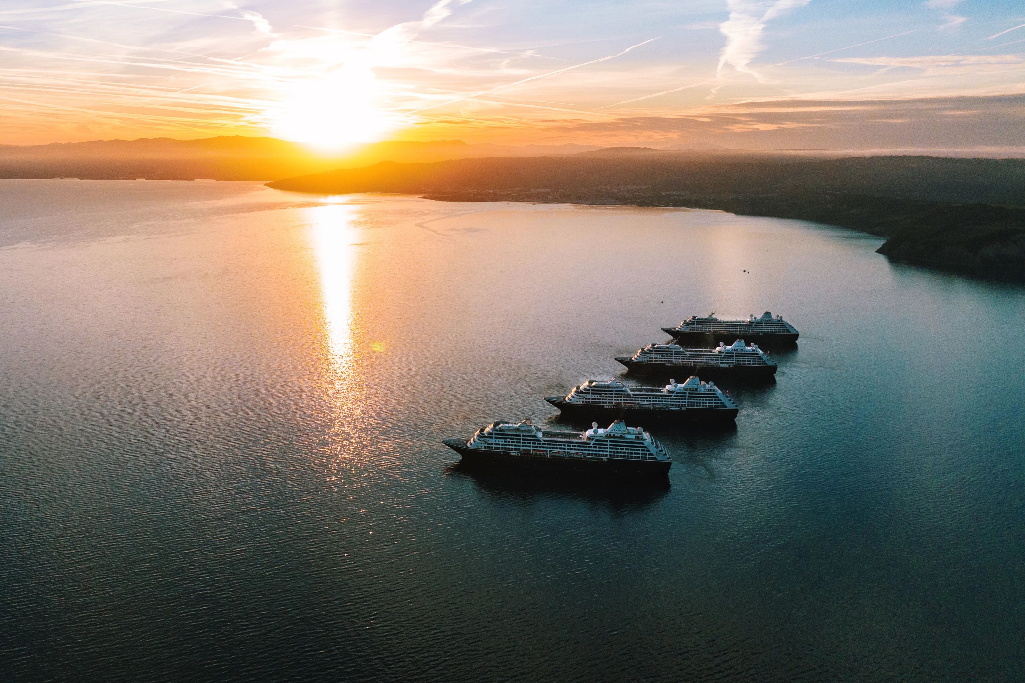 The four Azamara® ships meet against a sunset