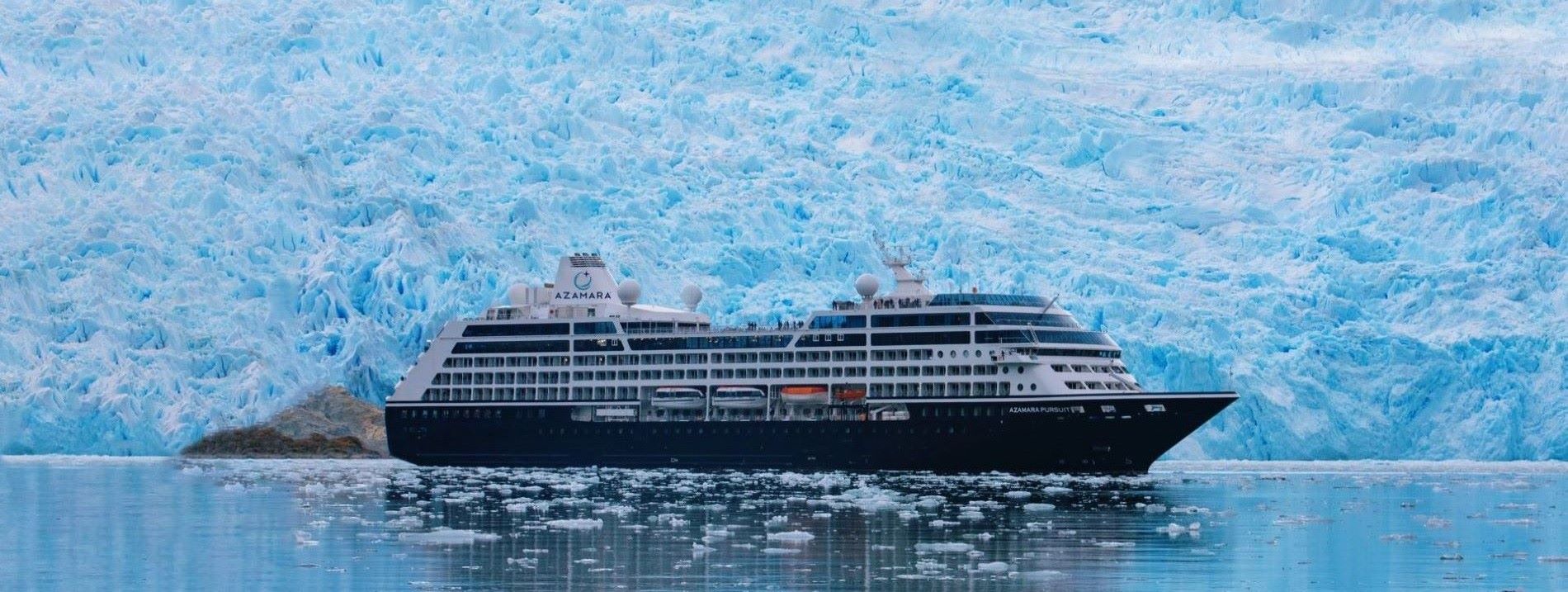 cruise ship in front of glacier