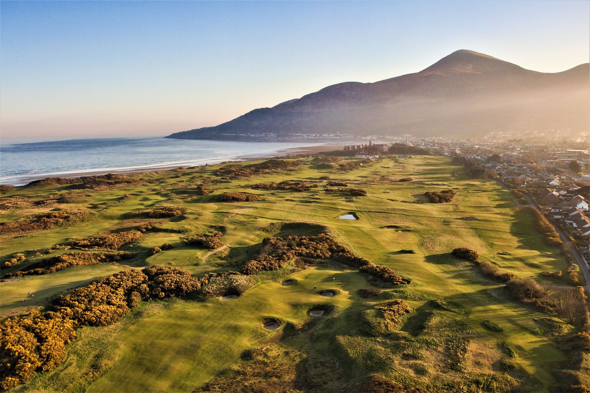 golf course with mountain in background at dusk