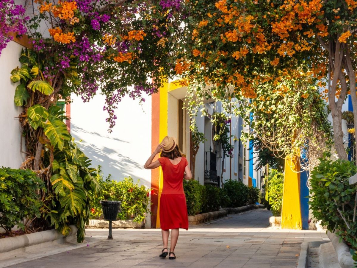 woman enjoying a stroll under a floral archway