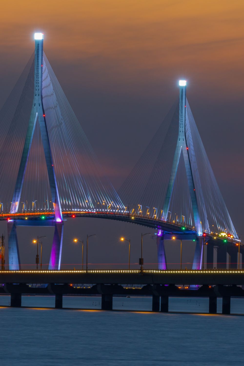 Illuminated Incheon Bridge at dusk
