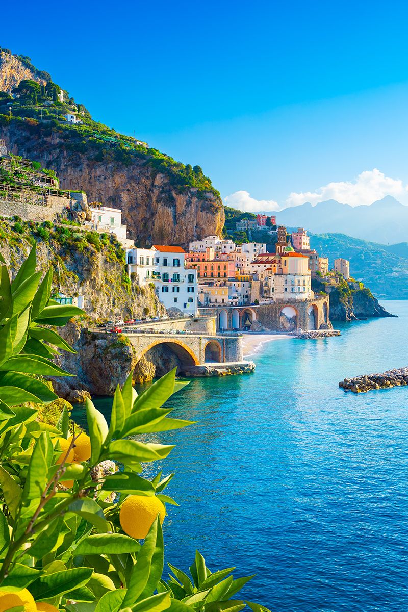 Amalfi Coast cliffside village overlooking turquoise water and lemon trees in southern Italy.