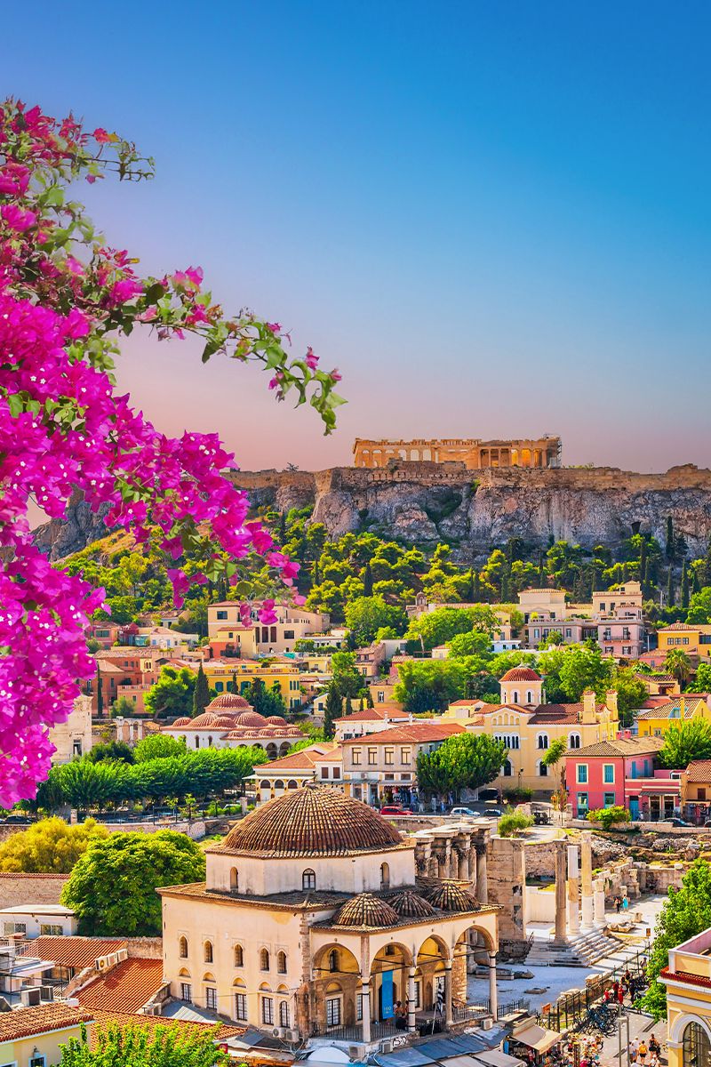 Athens cityscape at sunset with the Acropolis rising above historic Plaka.