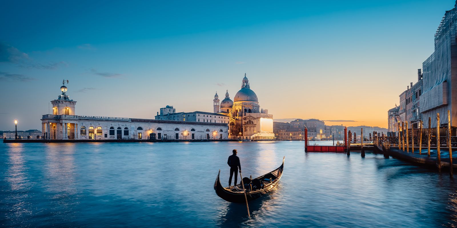 Venice, Italy Grand Canal at sunset with a gondola and views of Santa Maria della Salute.