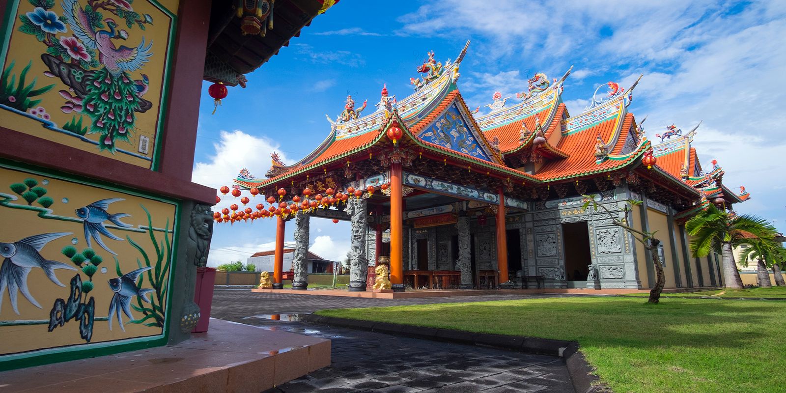 Benoa, Bali temple with colorful carvings, red lanterns, and traditional architecture.