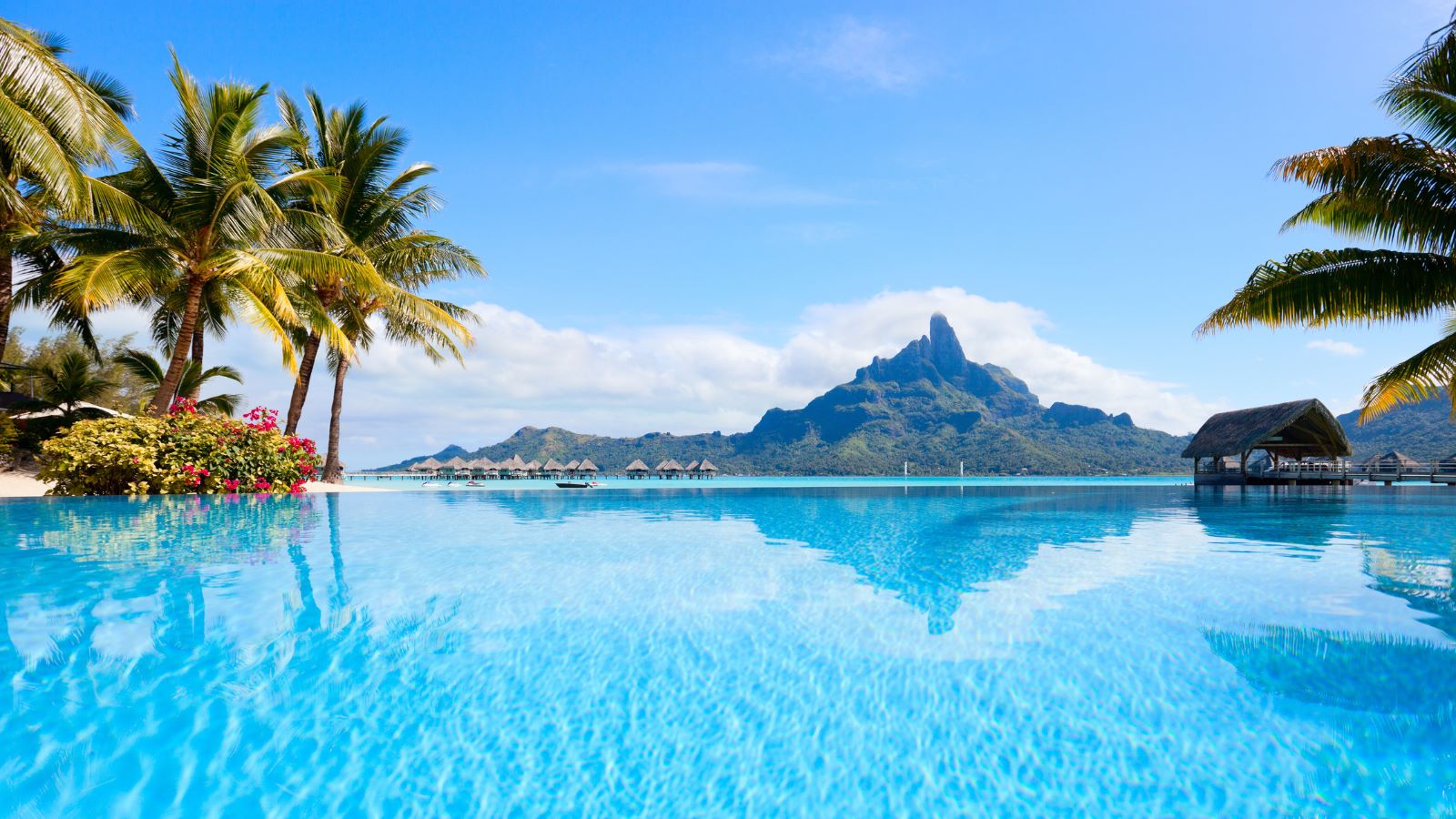 still blue water in lagoon with mountain in view