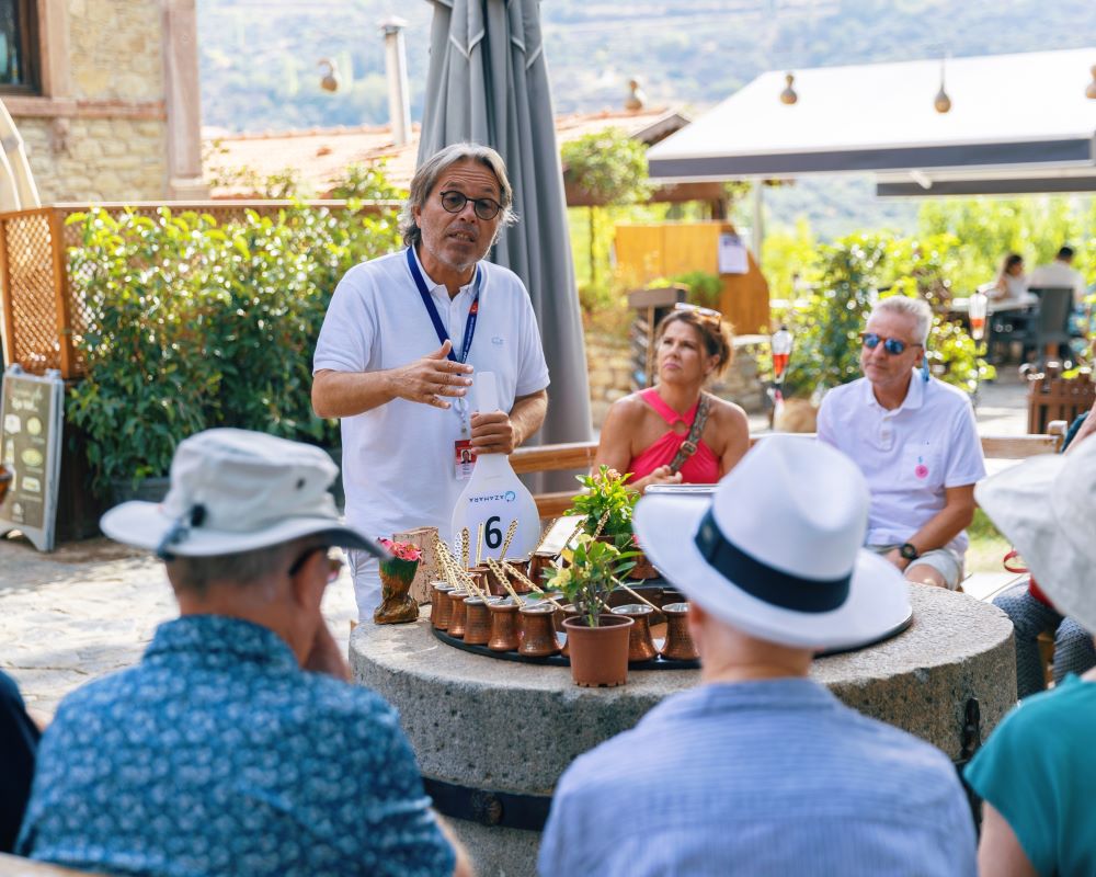 man speaking to small group around a table
