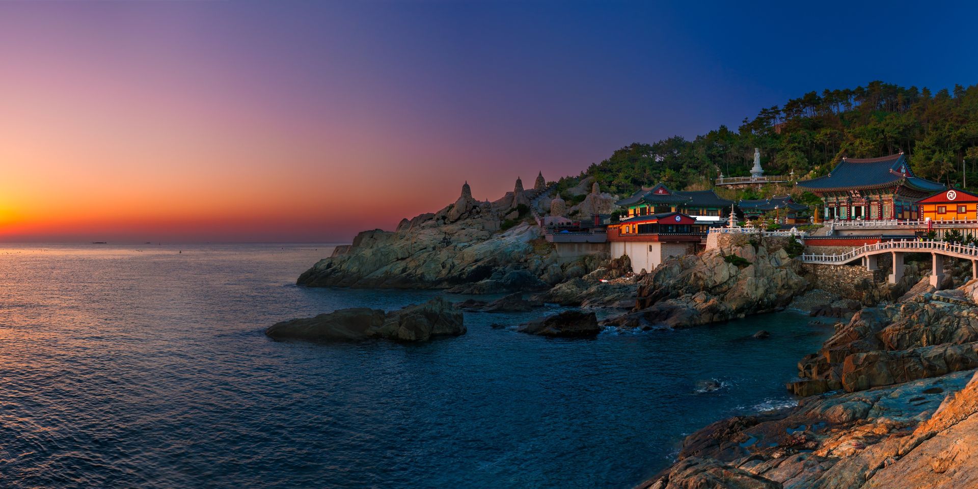 Coastal temple above rocky shores at dusk