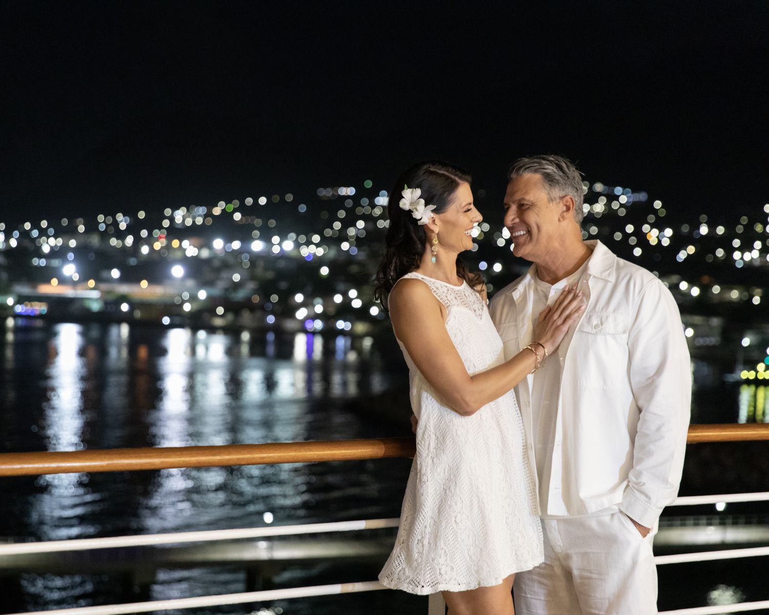 couple embraced on cruise deck at night