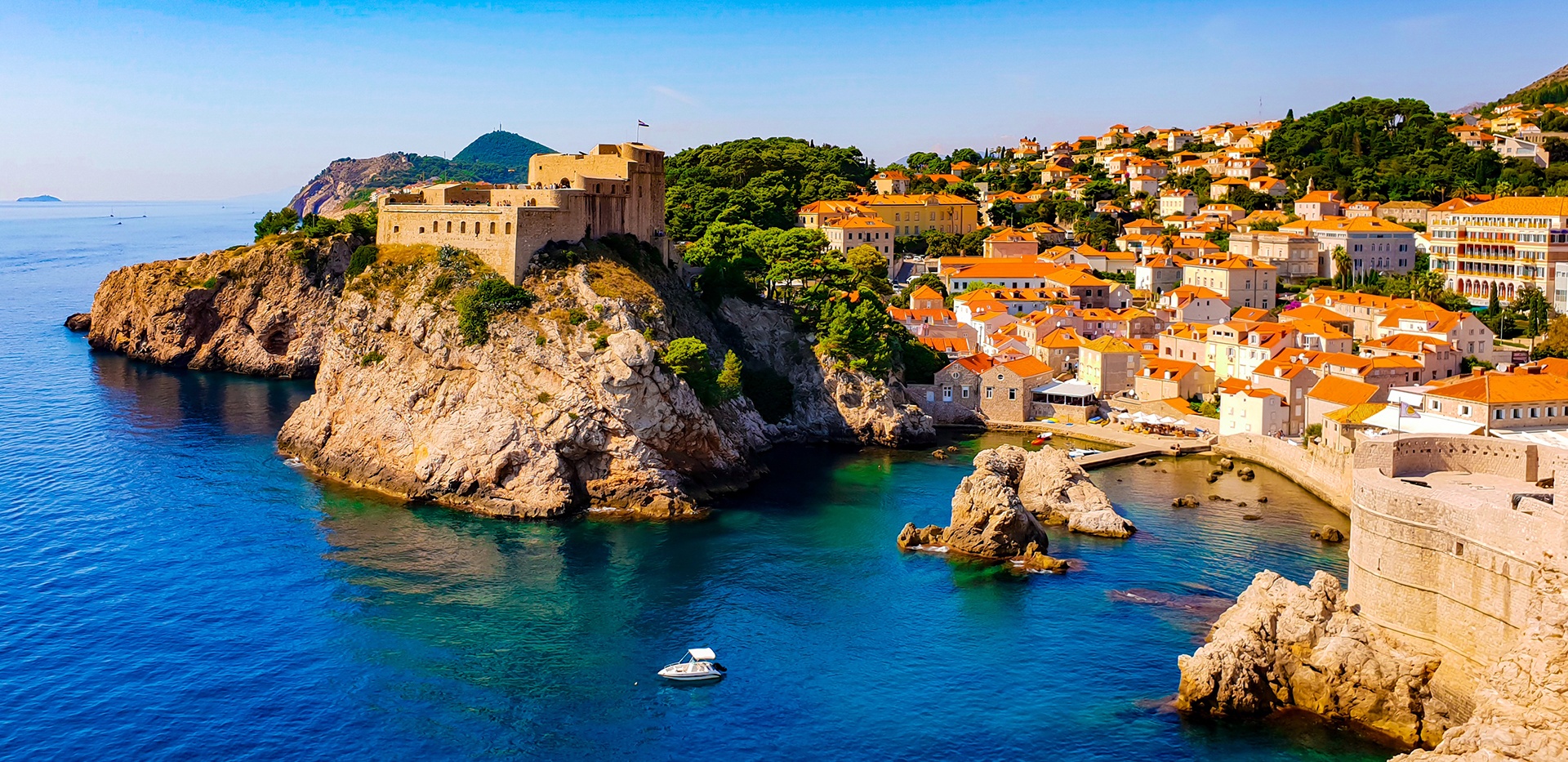 orange roof homes in cliffside village overlooking water