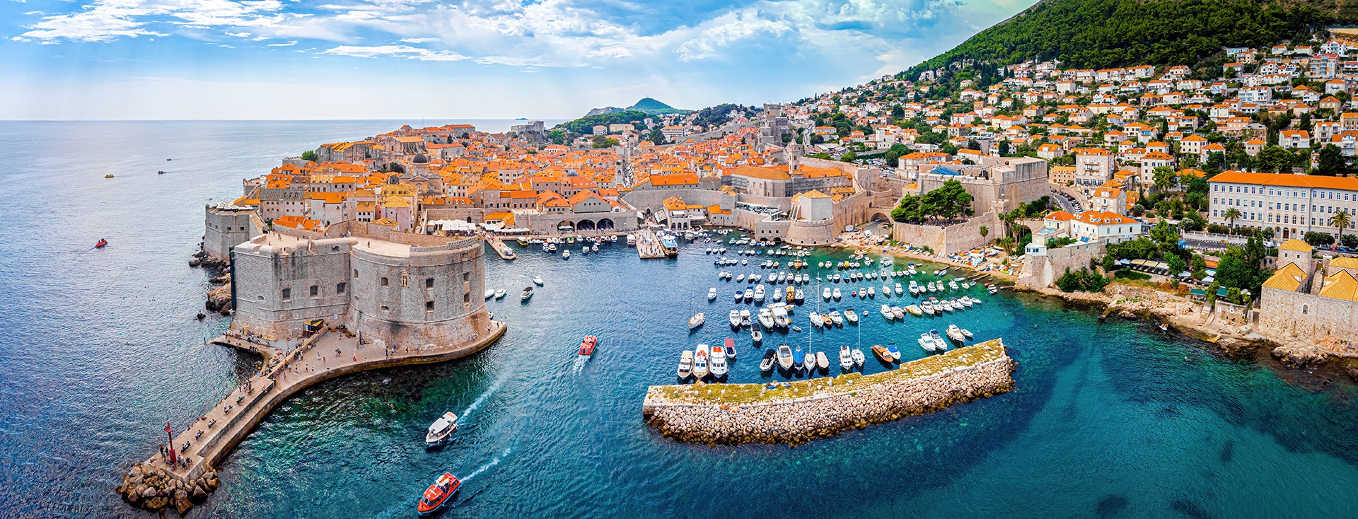 aerial view of seaside town and port of small boats