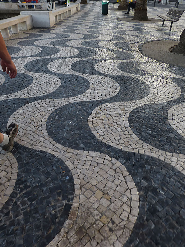Lisbon's beautiful mosaic sidewalks look like shimmering waves!