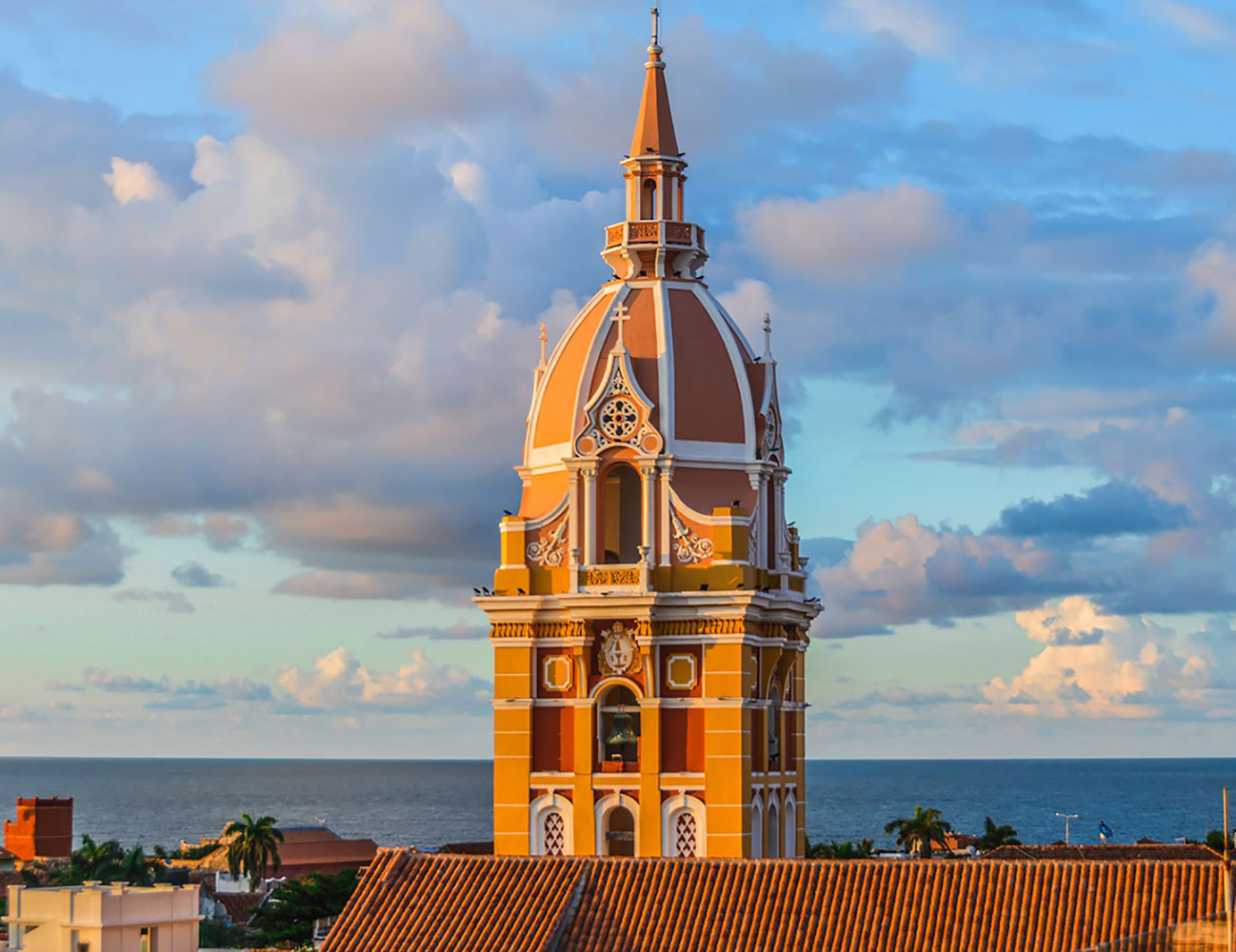 The steeple of Basílica Santa Catalina de Alejandría in Cartagena with the water in the background