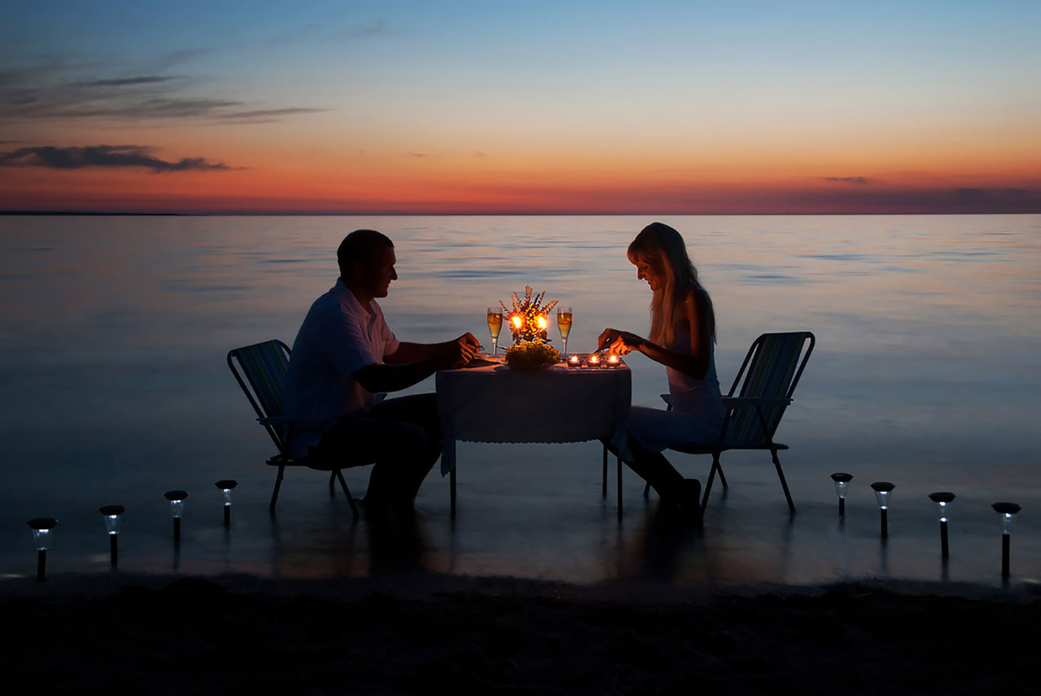 A couple enjoy a romantic candlelit dinner