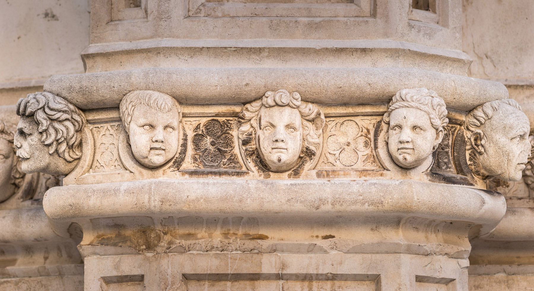 Stone faces on the exterior wall of the St. James Cathedral in Sibenik, Croatia.