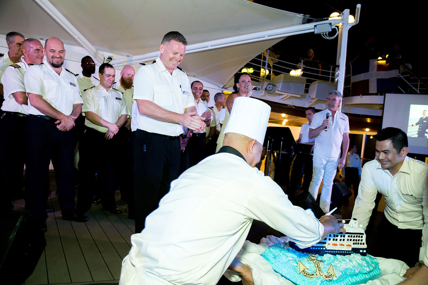 Cutting a cake in Captain Carl's honor onboard the Azamara Quest cruise ship.