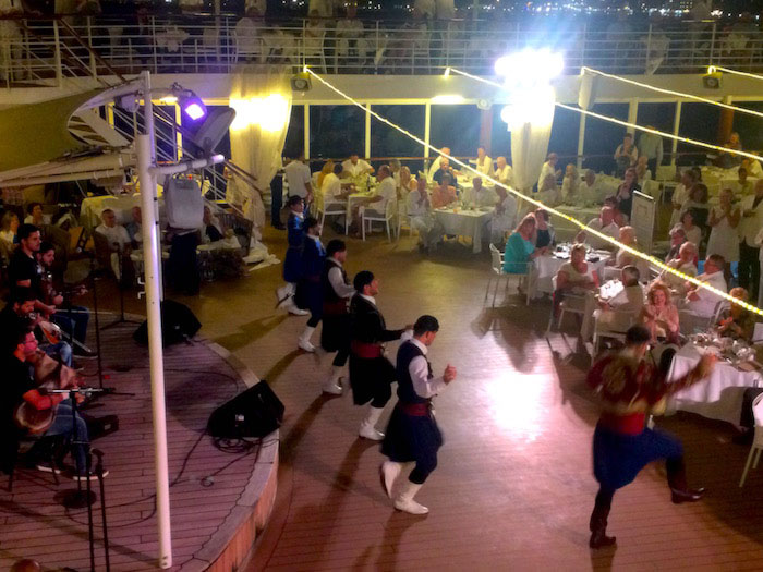 Performers doing a traditional Greek dance