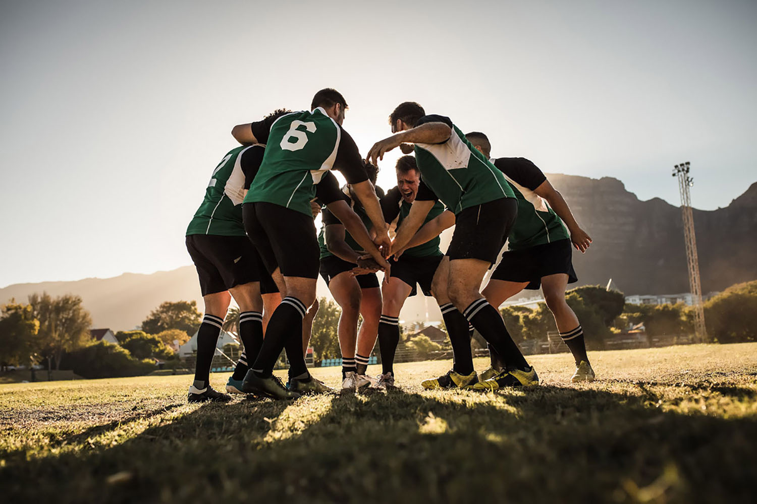 Rugby players gather in a scrum before the start of a match