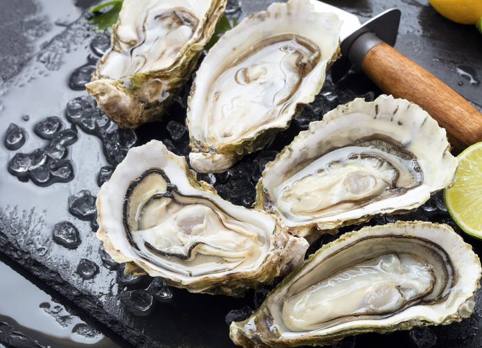 Fresh opened oysters with ice