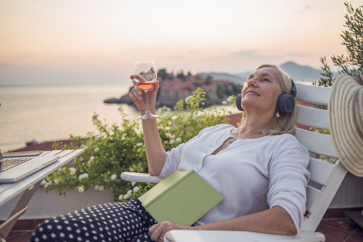 Woman enjoying on the balcony listening to music