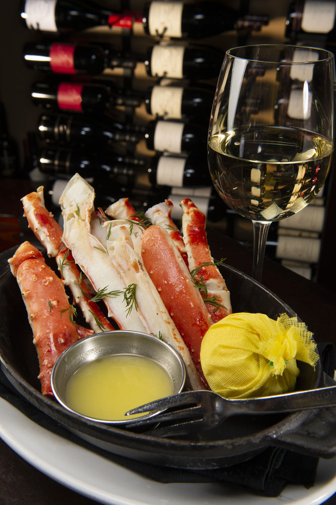 Alaskan King Crab Legs with Lemon and Butter served with white wine