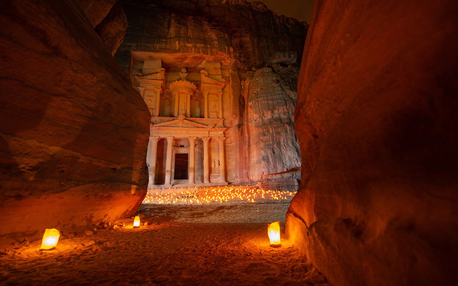 The ancient city of Petra lit by candles in the evening.