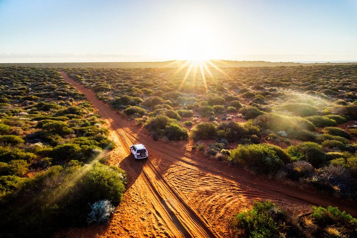 Driving in the outback of Australia at sunset