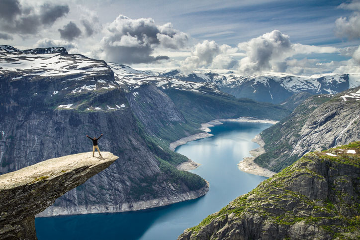 A man stands at Trolltunga in Norway