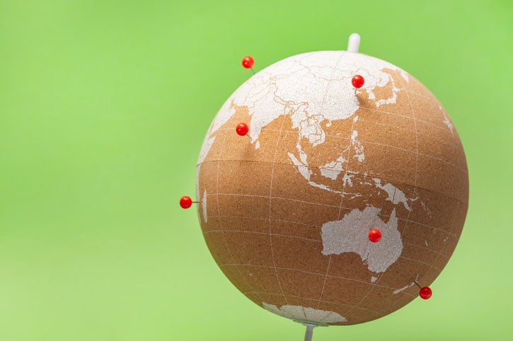 A cork globe with pins indicating destinations visited.