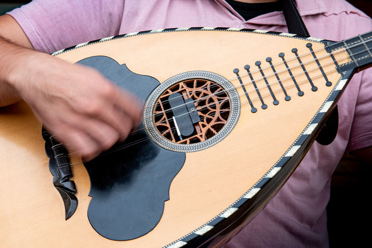 Greek musician playing a traditional song on the laouto