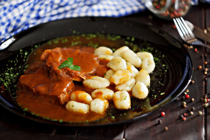 Pasticada with gnocchi, beef stew in a sauce