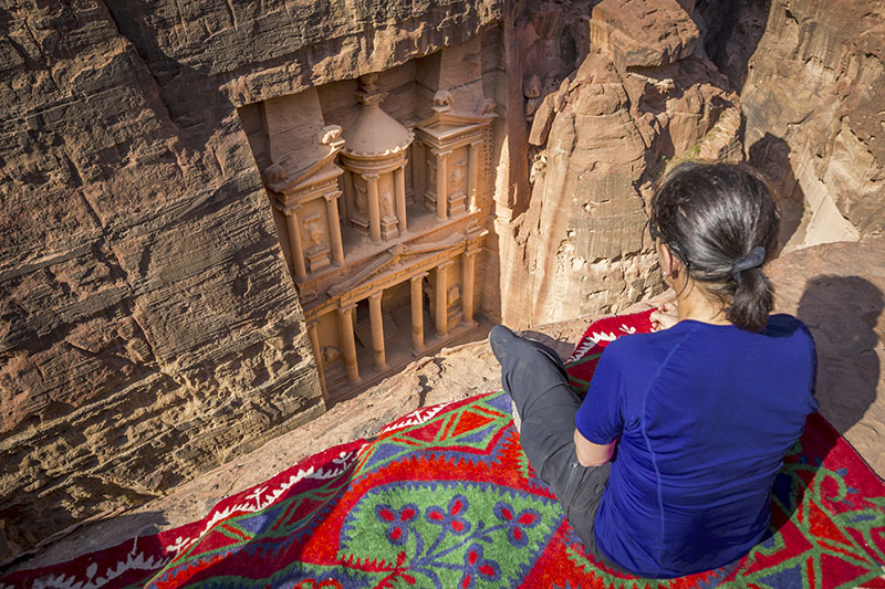 Woman traveler sitting in Petra, Jordan