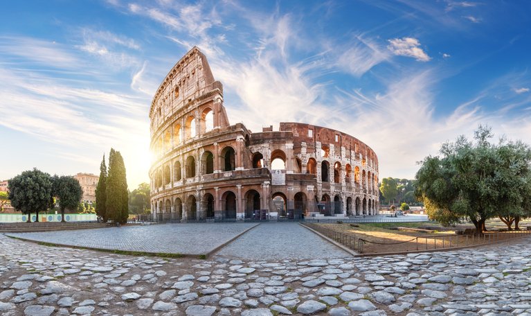 Roman Coliseum at sunset, summer view with no people, Italy