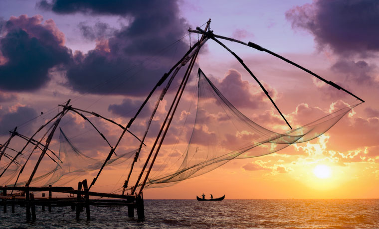 Sunset over Chinese Fishing nets and boat in Cochin