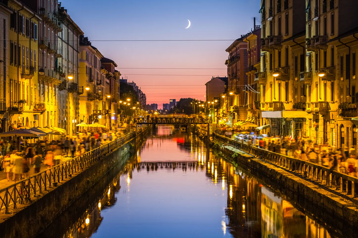 people walk along the canal in Milan.