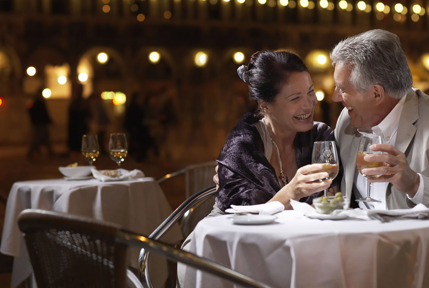 A couple at restaurant table at night in Venice