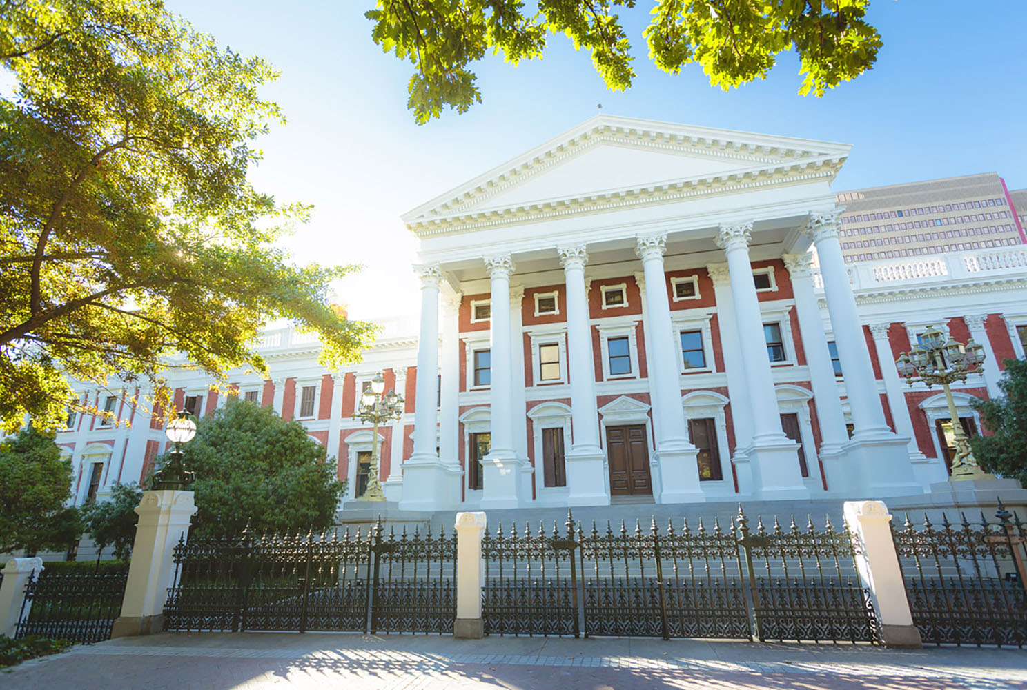 The parliament building in Cape Town, South Africa is pink with columns.