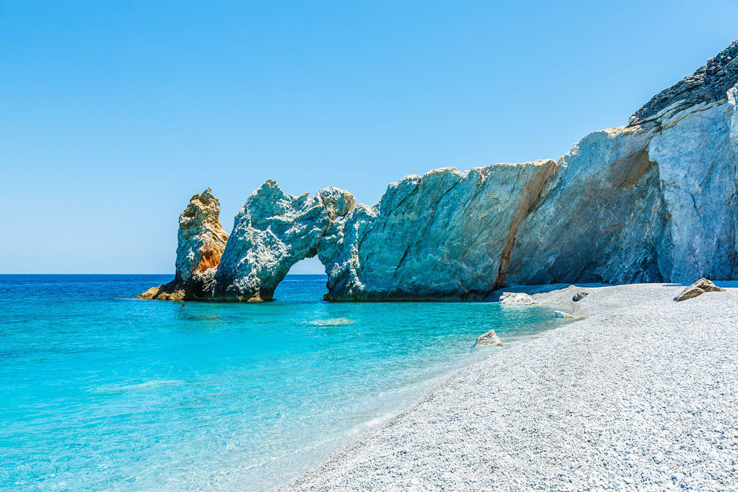 Famous hole in the rock formation at Lalaria beach in Skiathios, Greece.