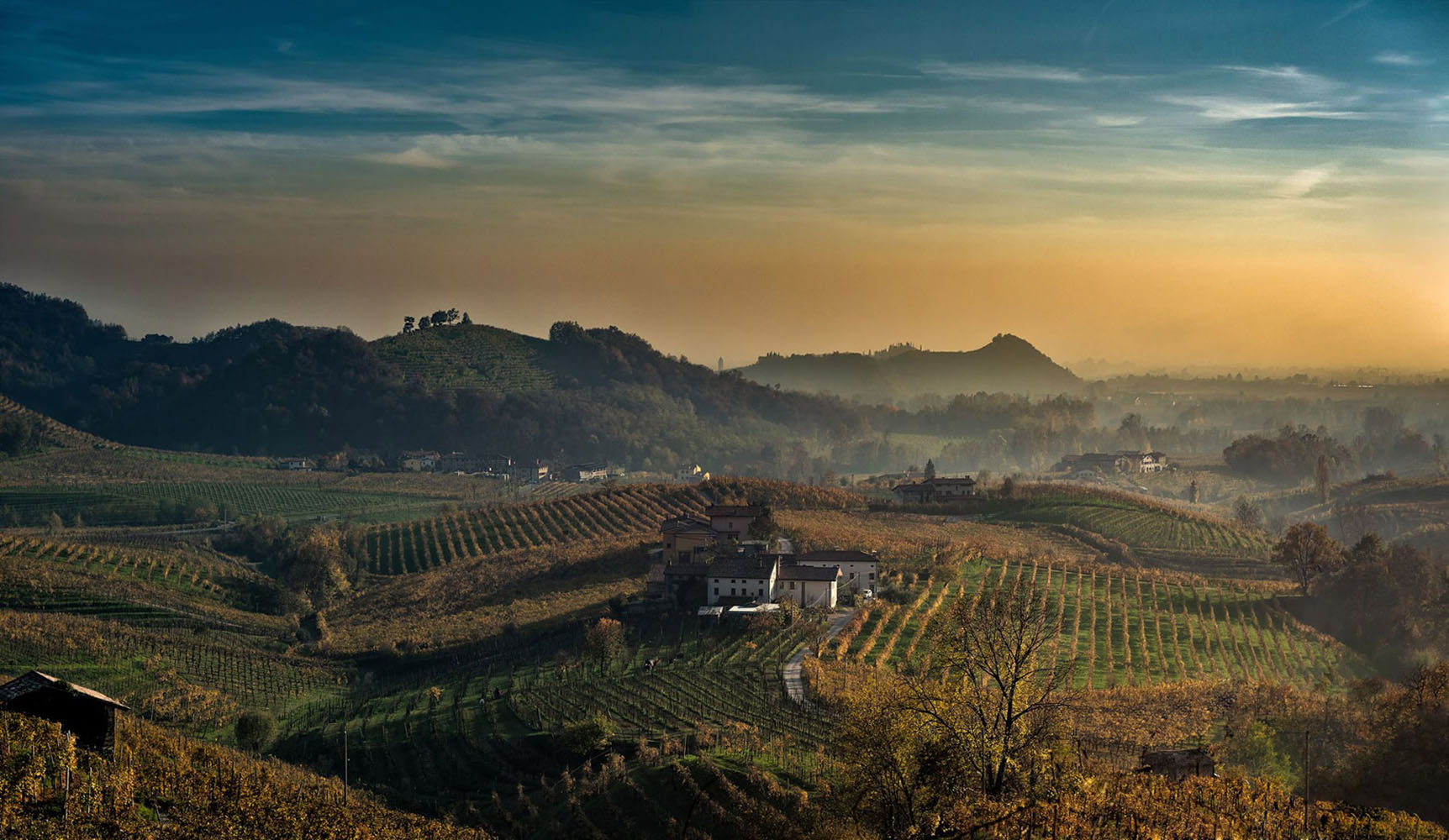 The sun sets beyond the Prosecco hills