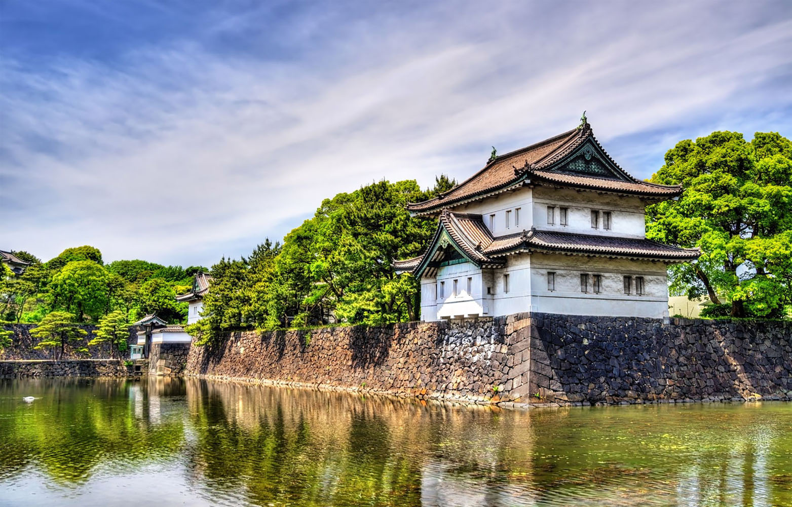 A Japanese castle near the water on a sunny day