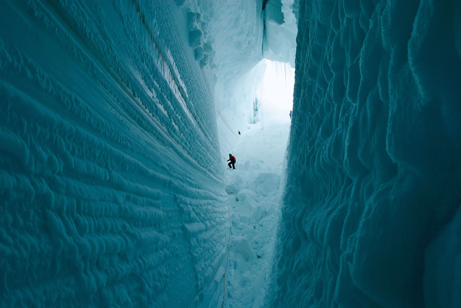 Researchers explore a deep crevice in Antarctica.