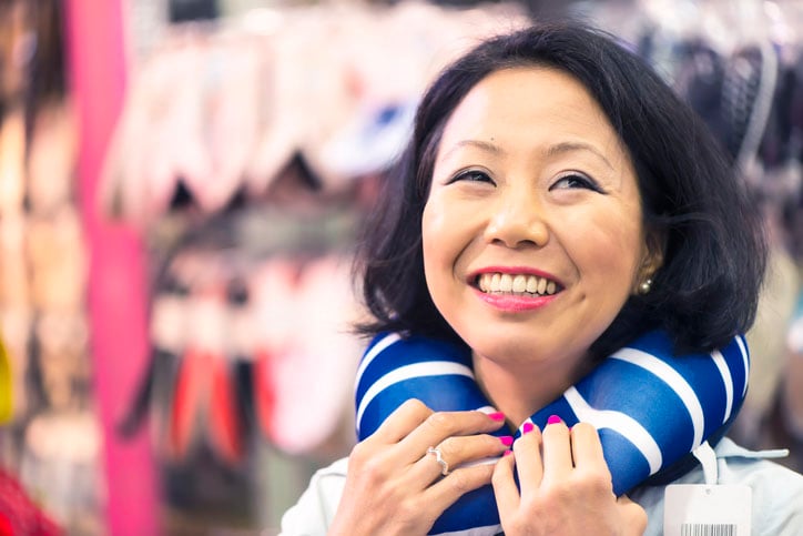A Japanese women wearing a neck pillow