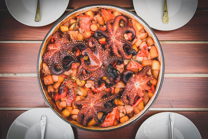 Preparing and Cooking of octopus in traditional Croatian peka sac sach